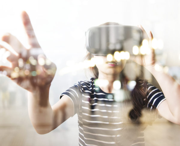 Double exposure of woman using the virtual reality headset